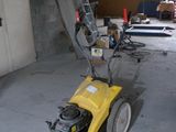 a yellow machine that is sitting in a garage
