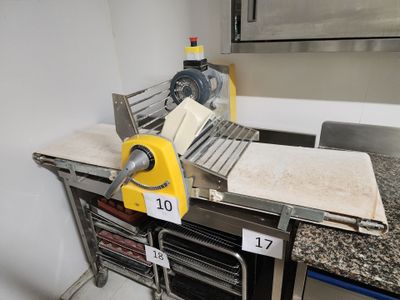 a picture of a kitchen with a counter top and a pizza cutter