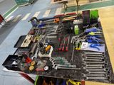 a table with many tools on it in a garage