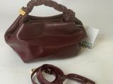 an image of a brown handbag and a leash on a white surface