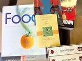 several books are stacked on top of each other on a table