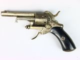 a silver revolver with a black handle on a white surface
