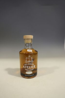 a bottle of alcohol sitting on a table next to a glass of wine