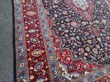 a rug on the ground with a cat sitting on it