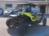 an image of a yellow and black utv parked in a parking lot