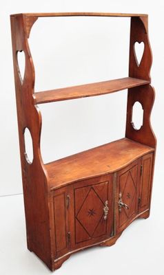 an old wooden bookcase with two open shelves and two doors