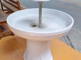 a white sink sitting on top of a yellow table