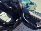 a black car with its door open on the side of the road
