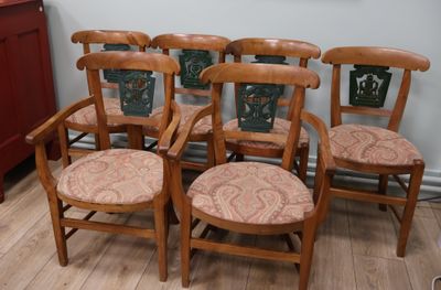 six wooden chairs that are lined up on the floor