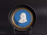blue and white portrait of a man in profile in a gold frame