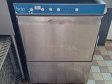 an image of a dishwasher sitting on a tiled floor in a kitchen