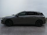 the grey car is parked on the concrete floor in the room