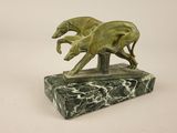 statue of two greyhounds running on a marble base