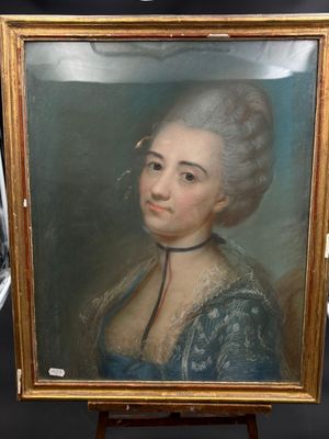 un vieux tableau représentant une femme en robe bleue, posé sur un chevalet