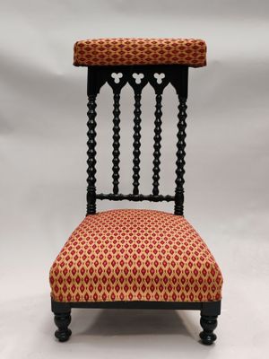 une chaise rouge et noire posée sur un fond blanc