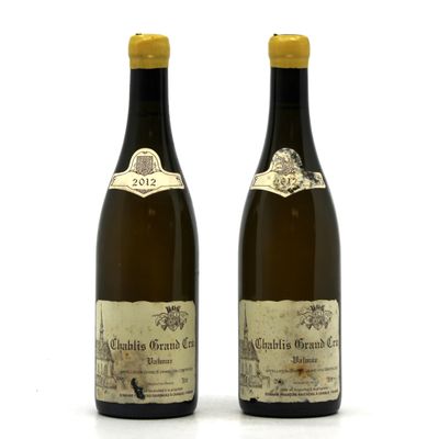 two bottles of wine sitting next to each other on a white surface