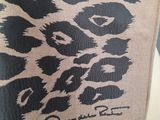 a close up of a towel on a white plate with a black and white animal print on it