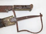 two old knives that are on a white table