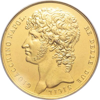 a close up of a gold coin with a woman ' s face