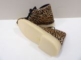 pair of leopard print shoes sitting on a white surface