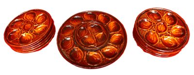 three pieces of carved glass with flowers on them on a white surface