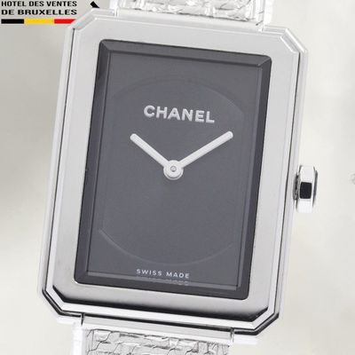 a silver watch with a black face on a silver bracelet