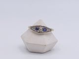 an image of a diamond and sapphire ring on a white background
