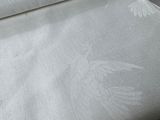 a roll of white fabric on a table next to a roll of white fabric
