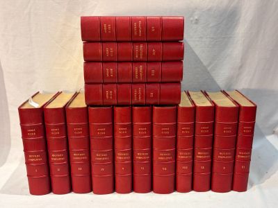 six red books stacked on top of each other on a white surface