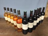 several bottles of wine are lined up in a row on a wooden table