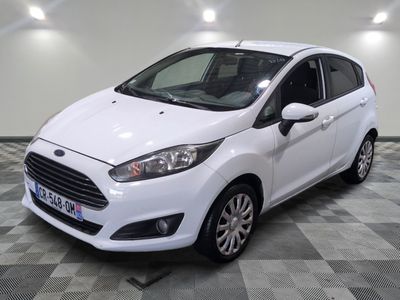 the white ford fiesta is parked in a room with a checkered floor