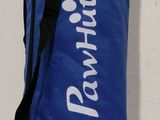 a blue duffel bag sitting on a white surface