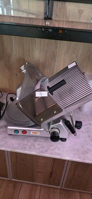 a meat slicer sitting on a counter in a kitchen