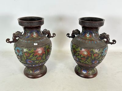 une paire de vases asiatiques ornés de motifs floraux, posés sur une table