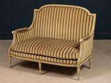 an image of a striped couch sitting on top of a carpeted floor