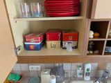 a sink in a kitchen with a lot of dishes on the counter