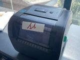 a printer sitting on a desk in front of a window