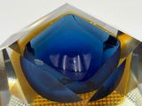 a blue glass bowl sitting on top of a table