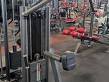a gym with a lot of machines in the room