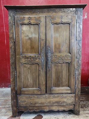 a wooden armoire with two doors in a room