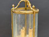 an antique brass and glass lantern hanging from a chain