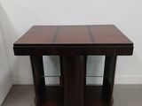 a wooden table with two glass shelves on top of it