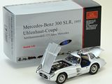 a silver model of a car with its hood open