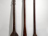 three wooden spoons and a knife on a white surface