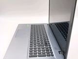 a silver laptop with a black keyboard on a white surface
