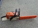 a chainsaw sitting on the ground in a parking lot