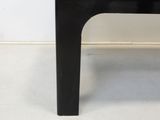 an image of a black coffee table in the corner of a room