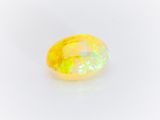 a yellow oplite gems on a white background