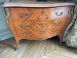 a wooden chest of drawers with a tv on top of it