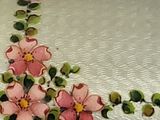 a white box with pink flowers painted on it